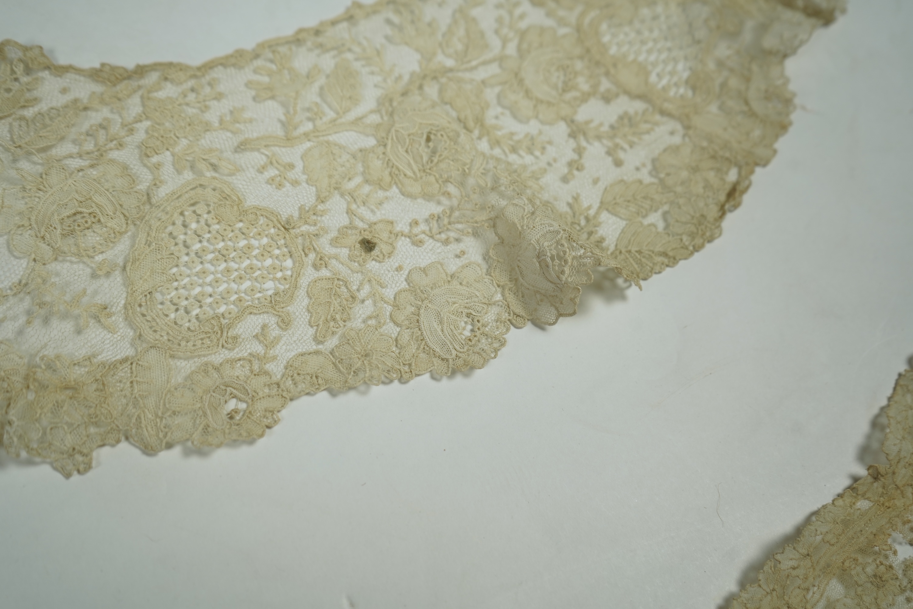 A 19th century Brussels Point de Gaz needle lace collar, lappet and wedding hankie, possibly part of a trousseau. The collar having thirty four needle lace raised flower heads within the design. The collar 100cm long x 1